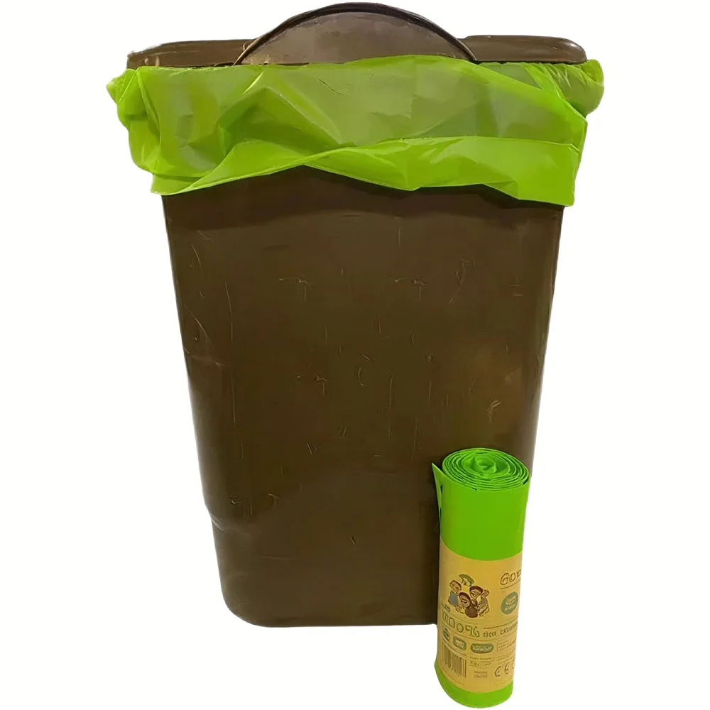 Bruine vuilnisbak met groene Eco Green Living composteerbare vuilniszak en rol vuilniszakken ernaast