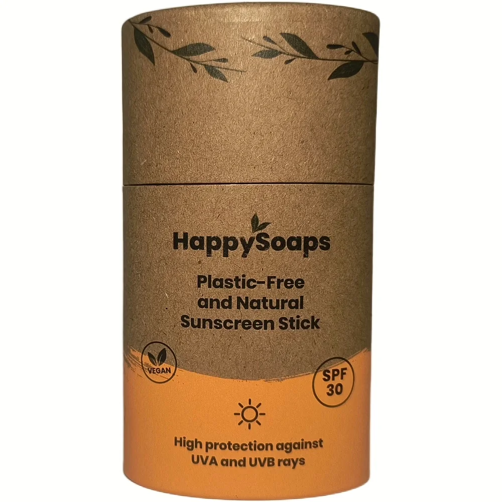 Kartonnen verpakking van HappySoaps natuurlijke zonnebrandstick SPF 30 met bladmotief